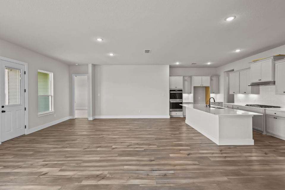A large kitchen with white cabinets.