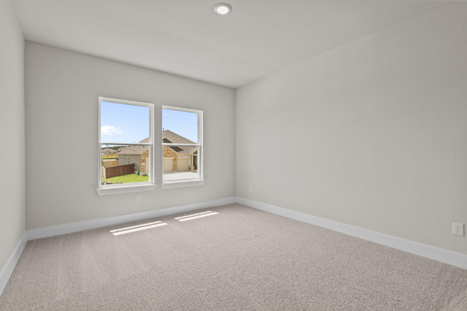 A room with a window and a carpet.