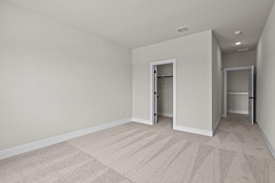 A room with a carpet and a door.