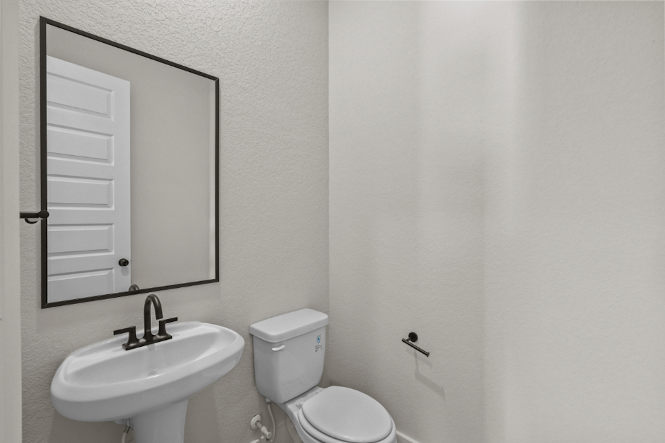 A bathroom with a toilet and sink.