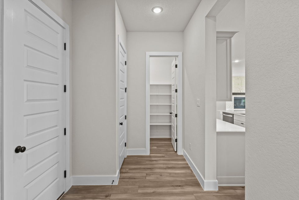 A white room with white cabinets.