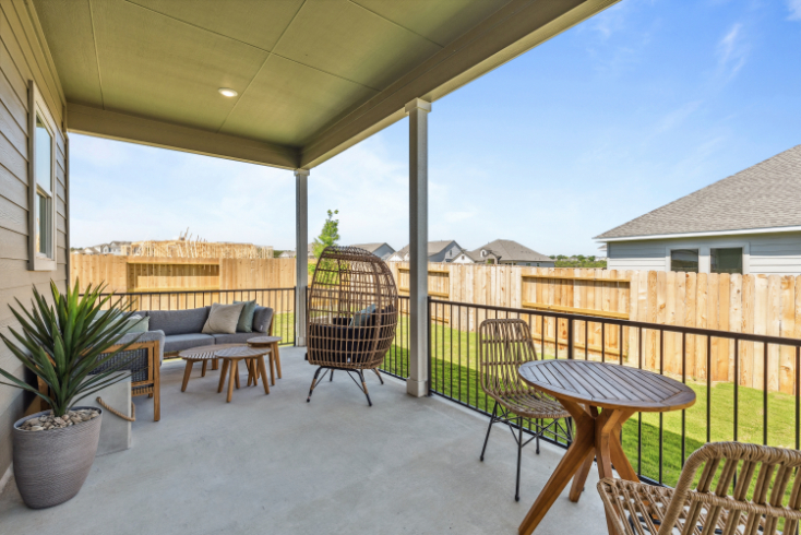A patio with a table and chairs.