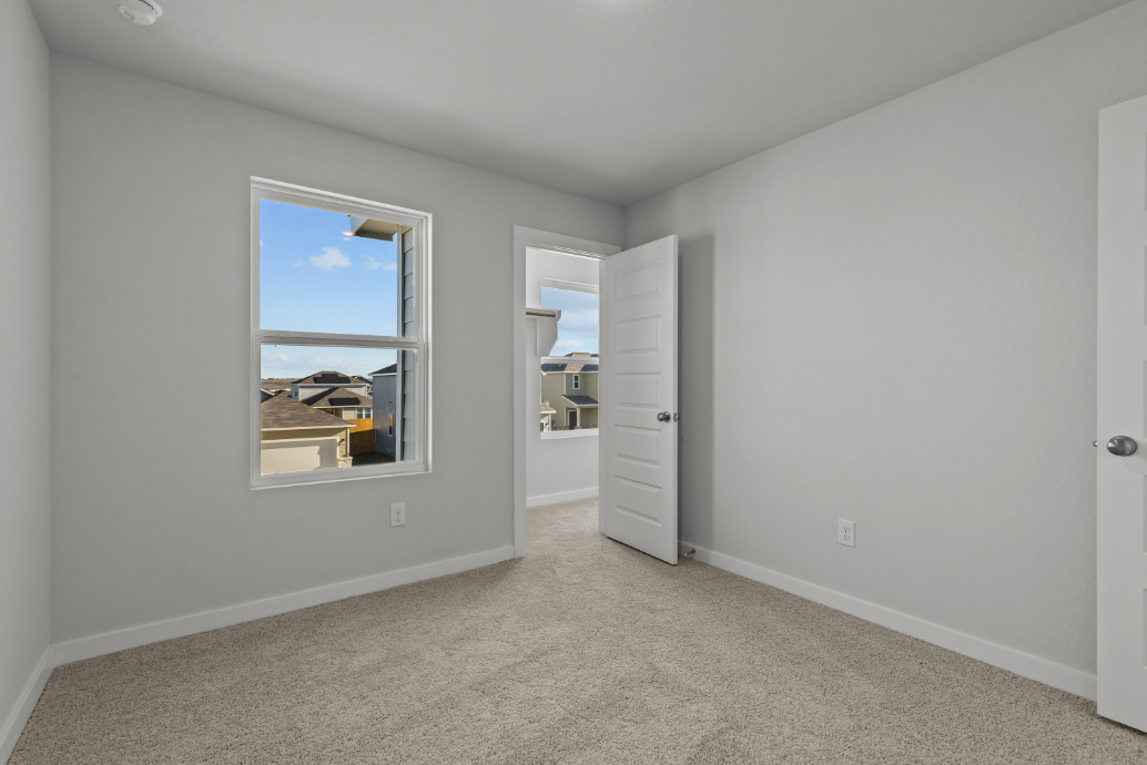 A room with a window and a door.