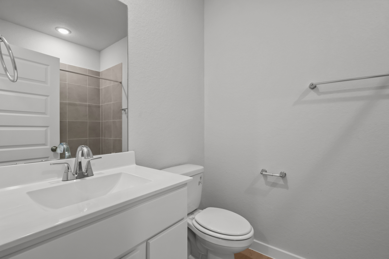 A bathroom with a tub sink and toilet.