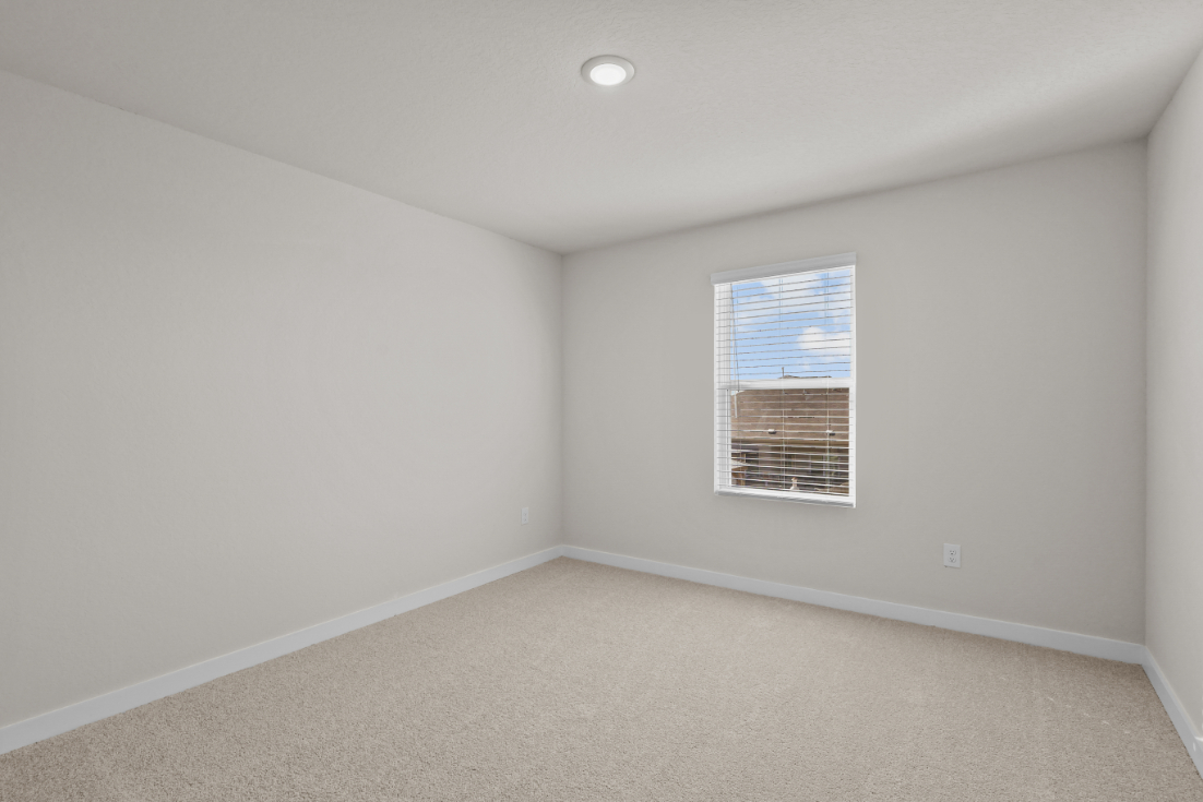 A room with a window and a vent.