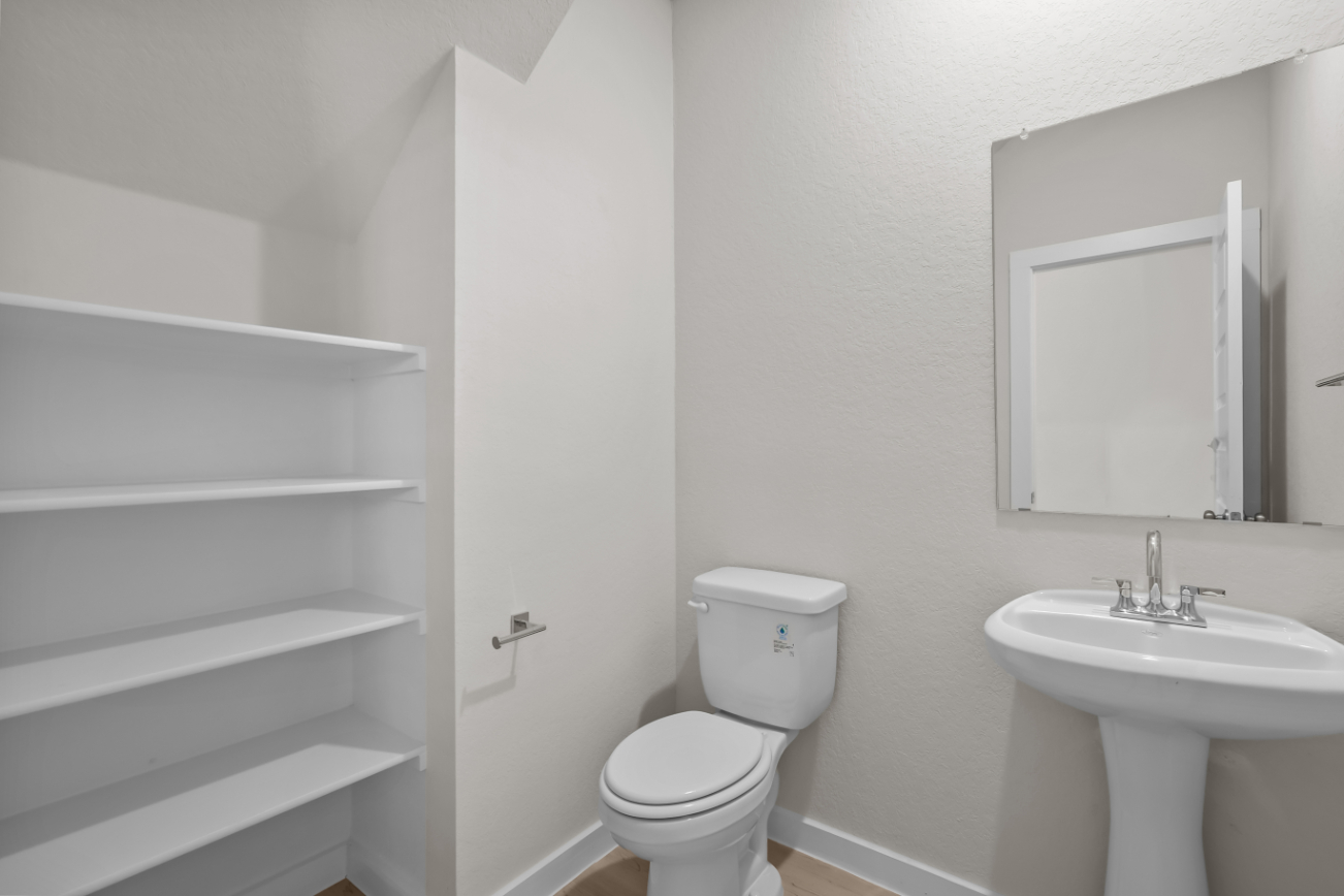A bathroom with a toilet and sink.