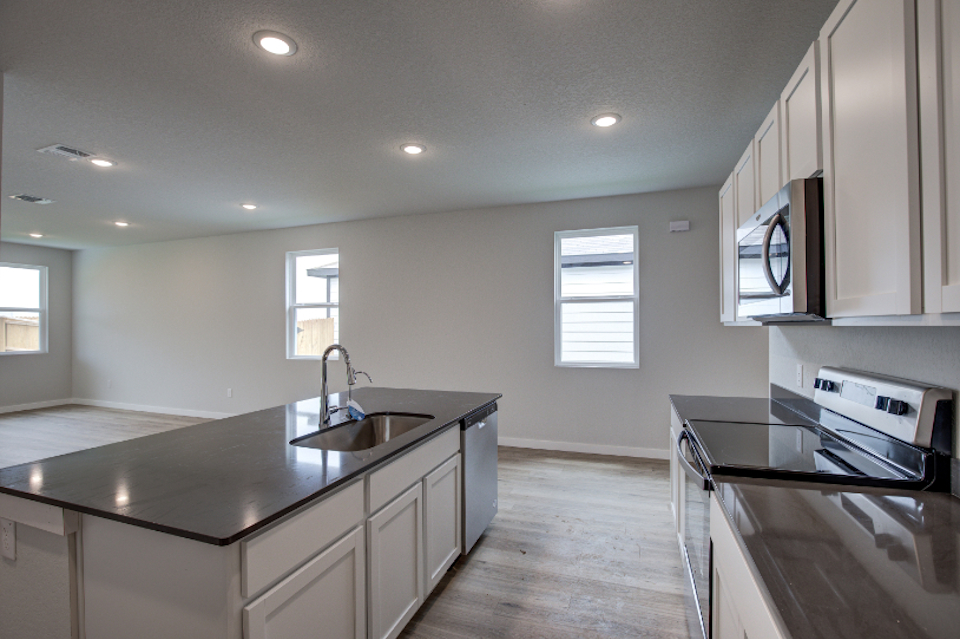 A kitchen with a sink and a stove.