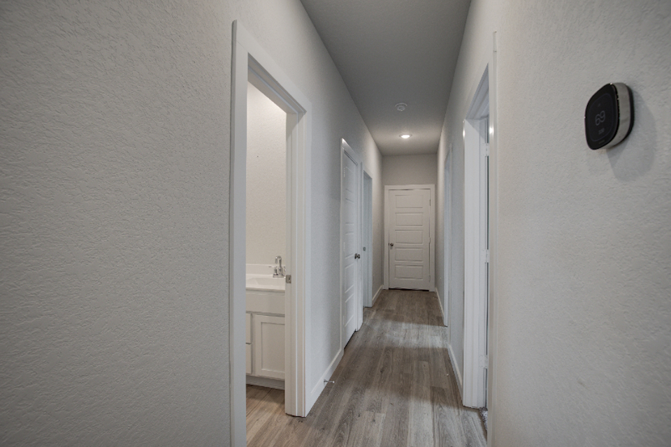 A hallway with white doors.