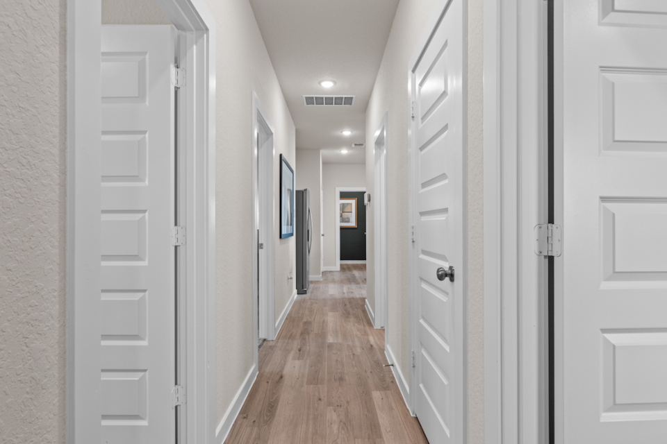 A hallway with white doors.
