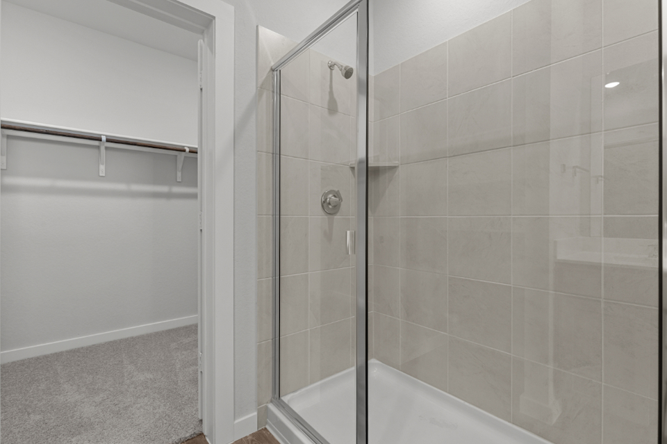 A shower with a glass door.