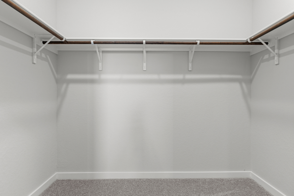 A white wall with a metal bar.