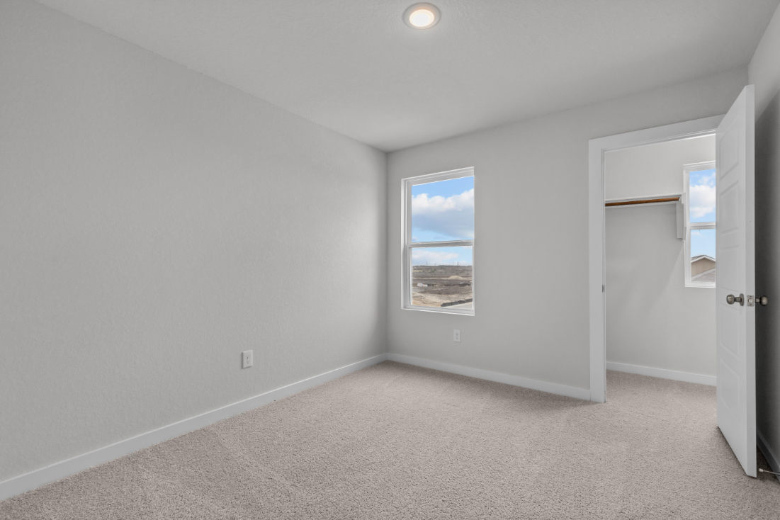 A room with a window and a door.