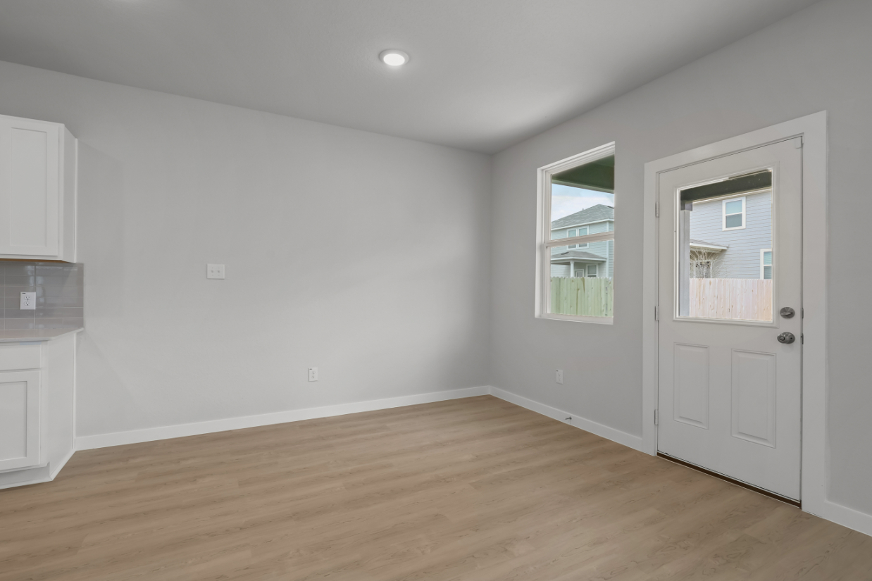 A room with white walls and a wood floor.