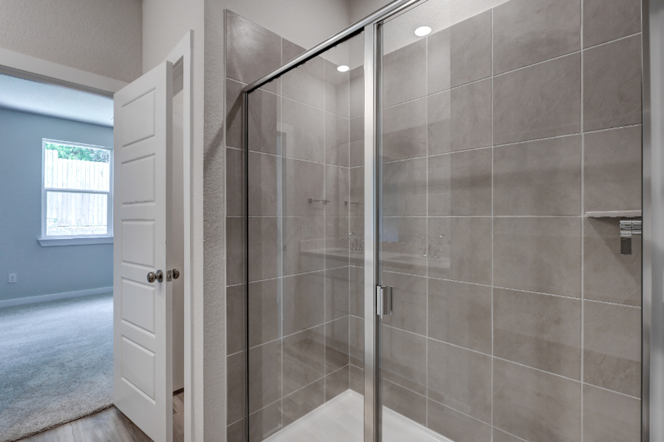 A shower with a glass door.