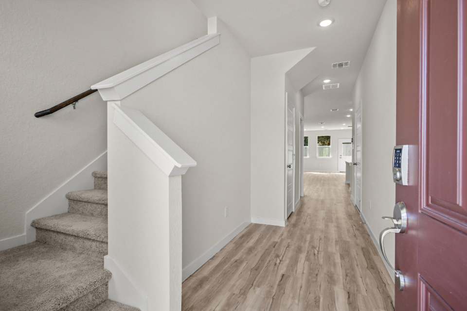 A hallway with white walls.