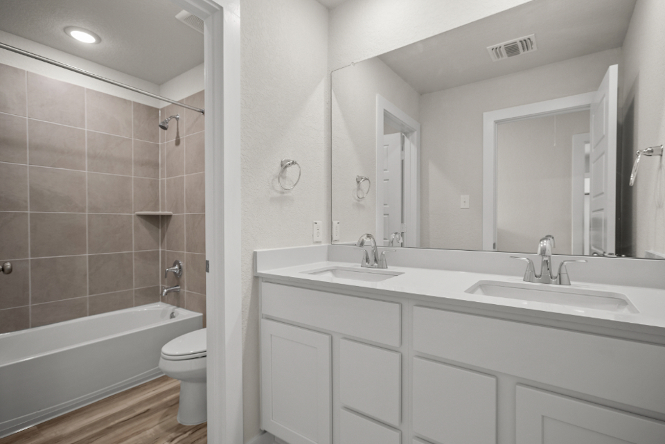 A bathroom with a tub sink and toilet.