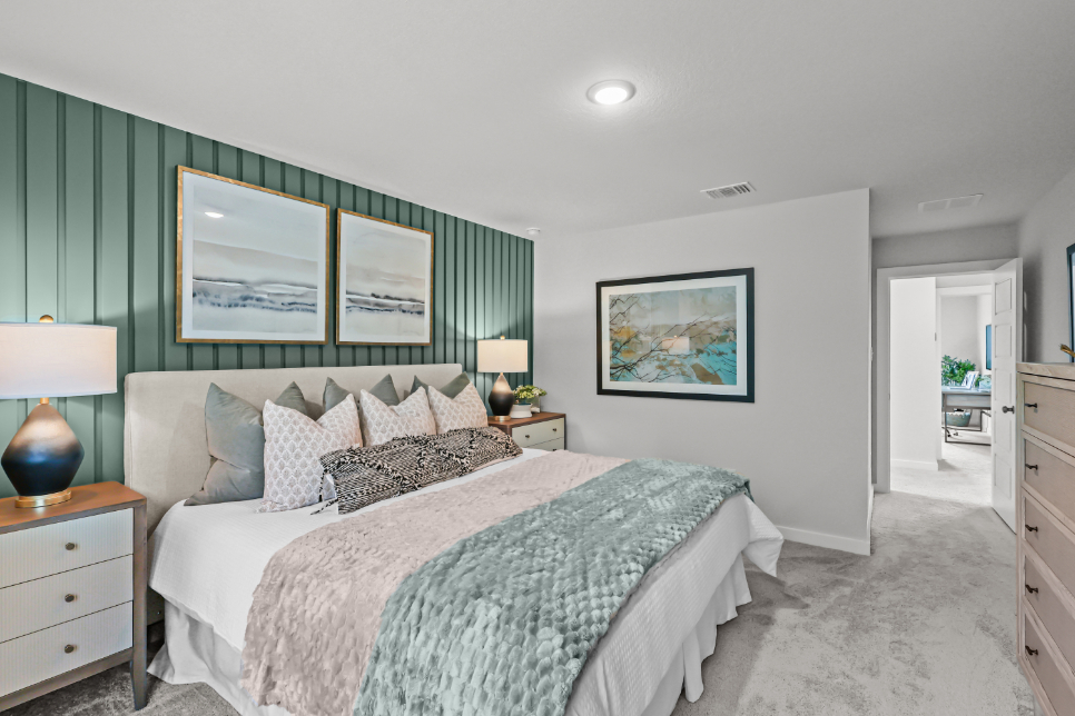 A bedroom with a bed and lamps.