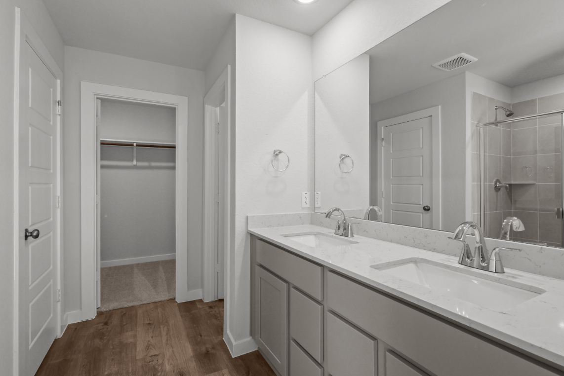 A bathroom with a large mirror.