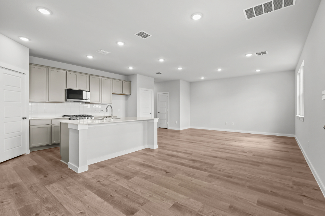A kitchen with white cabinets.