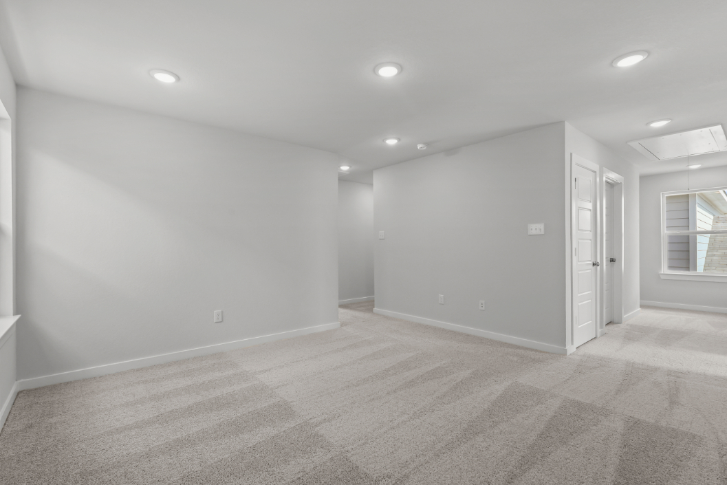 A room with white walls and a wood floor.