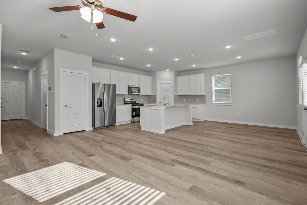 A kitchen with white cabinets.