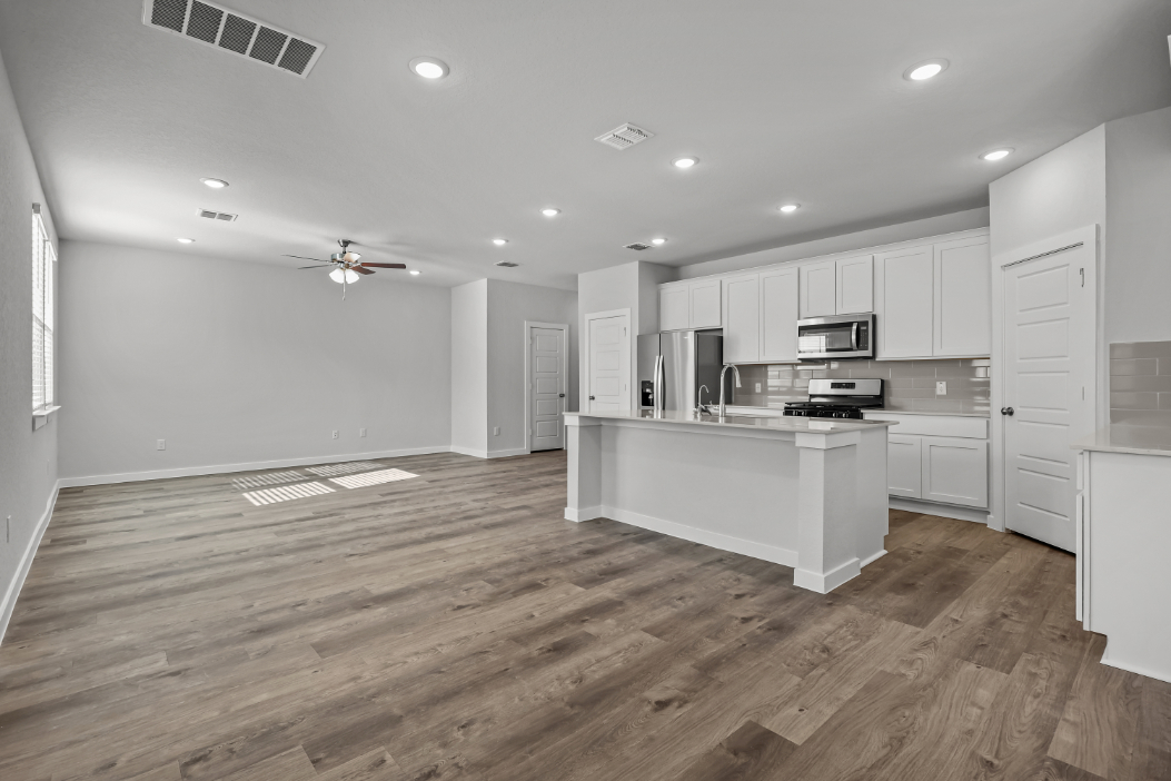 A kitchen with white cabinets.