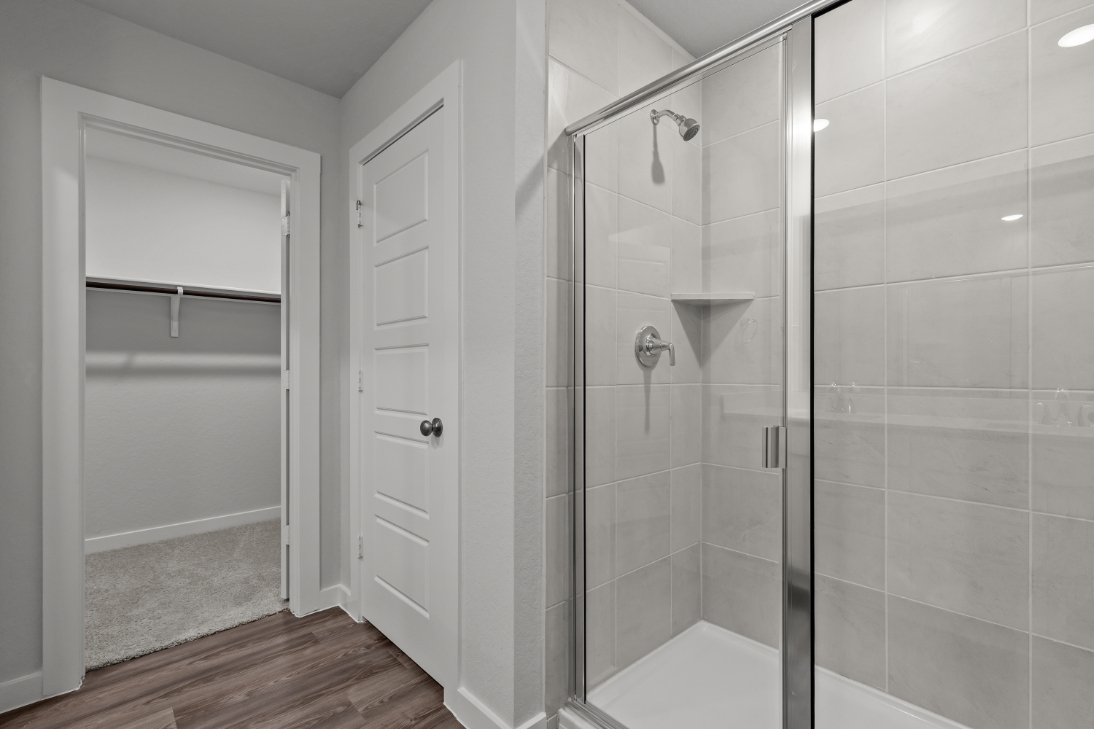 A shower with a glass door.