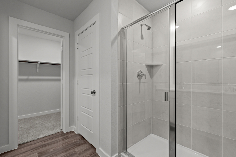 A shower with a glass door.
