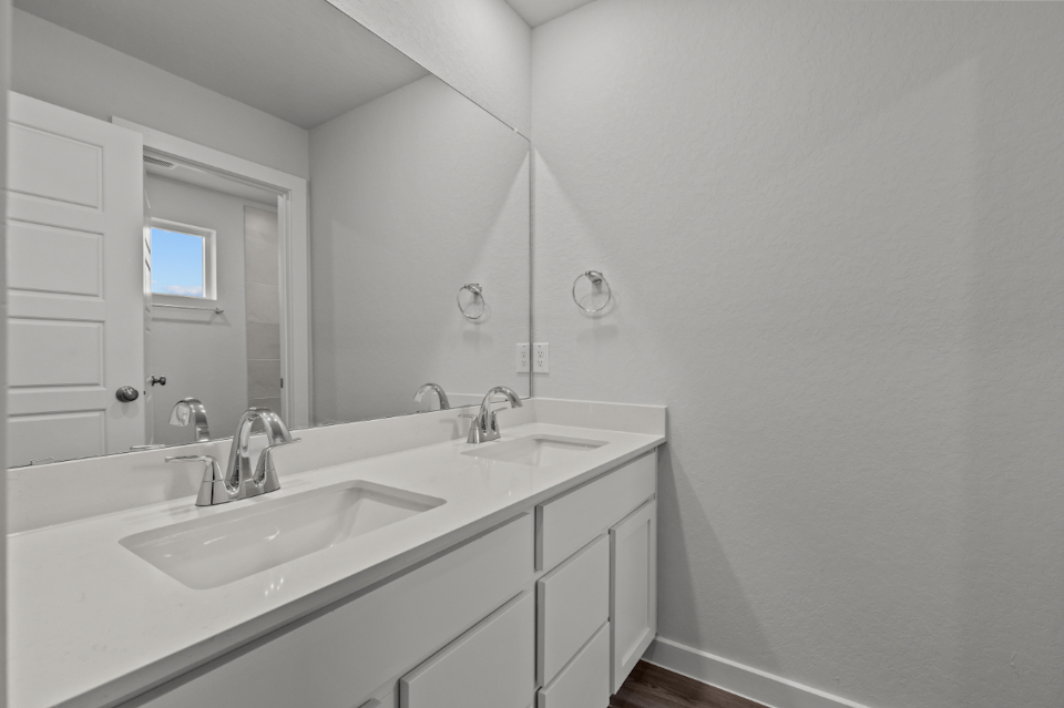 A bathroom with a large mirror.