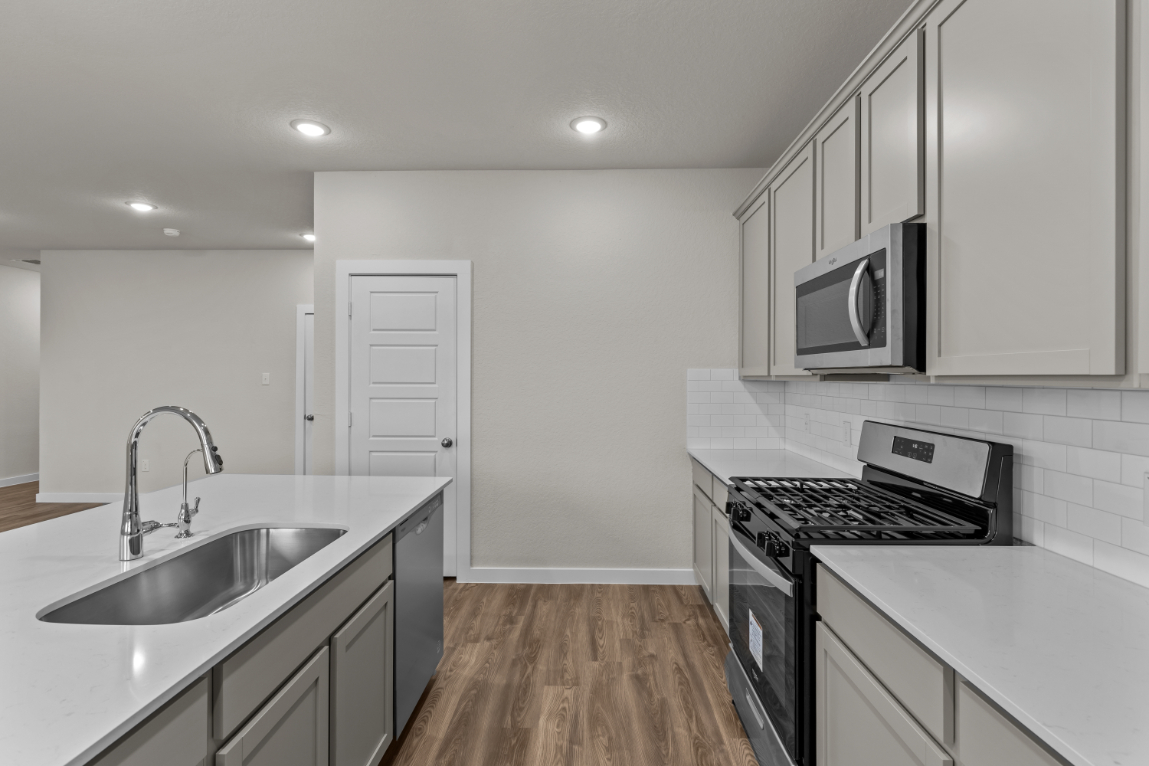 A kitchen with white cabinets.