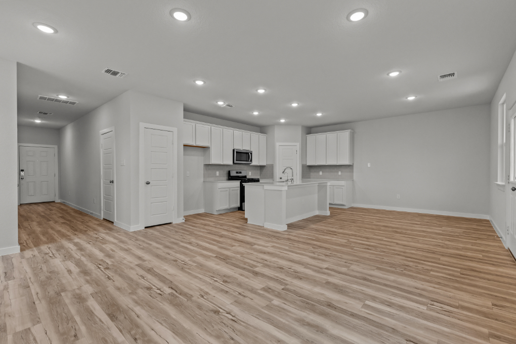 A large kitchen with white cabinets.