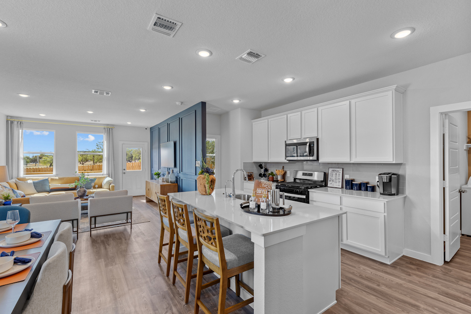 A kitchen with white cabinets.
