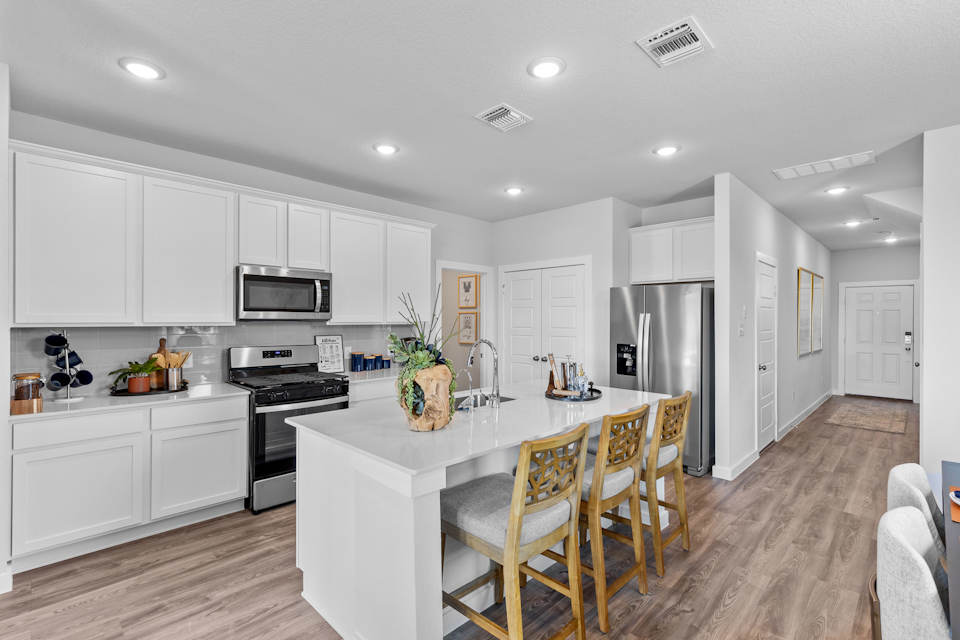 A kitchen with white cabinets.