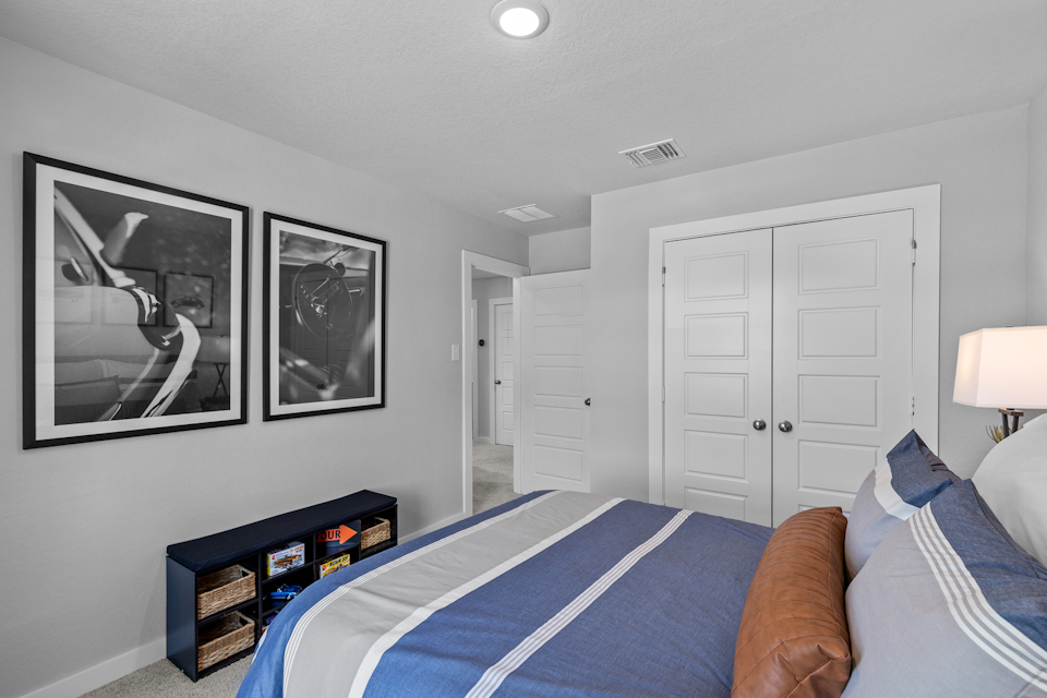 A bedroom with a bed and a couch.