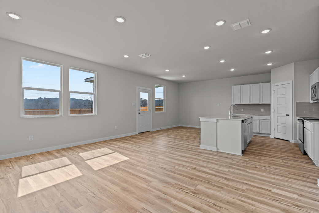 A large kitchen with white cabinets.