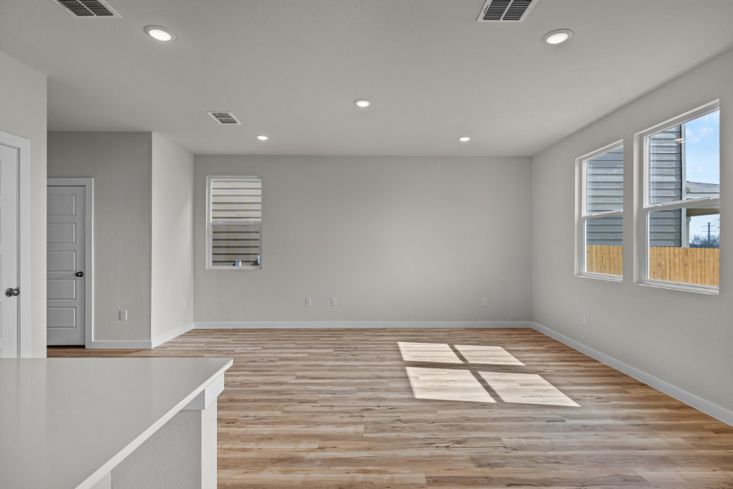 A room with a wood floor and white walls.
