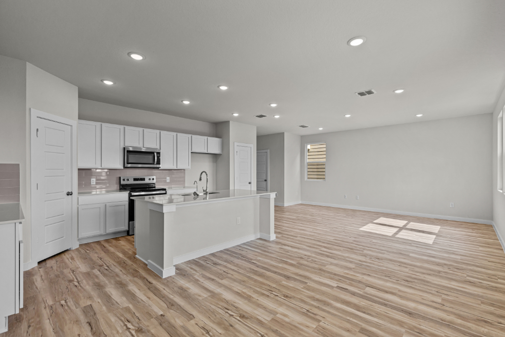 A kitchen with white cabinets.