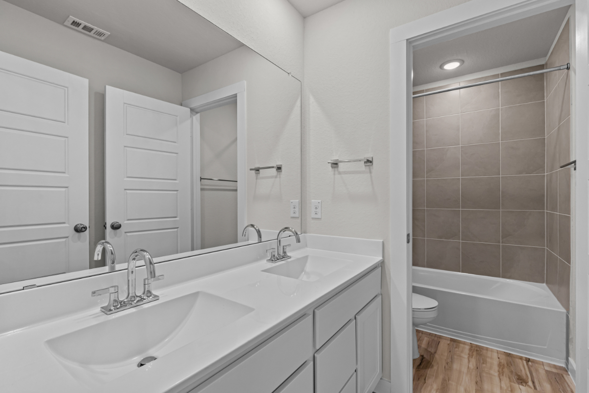 A bathroom with a tub sink and toilet.