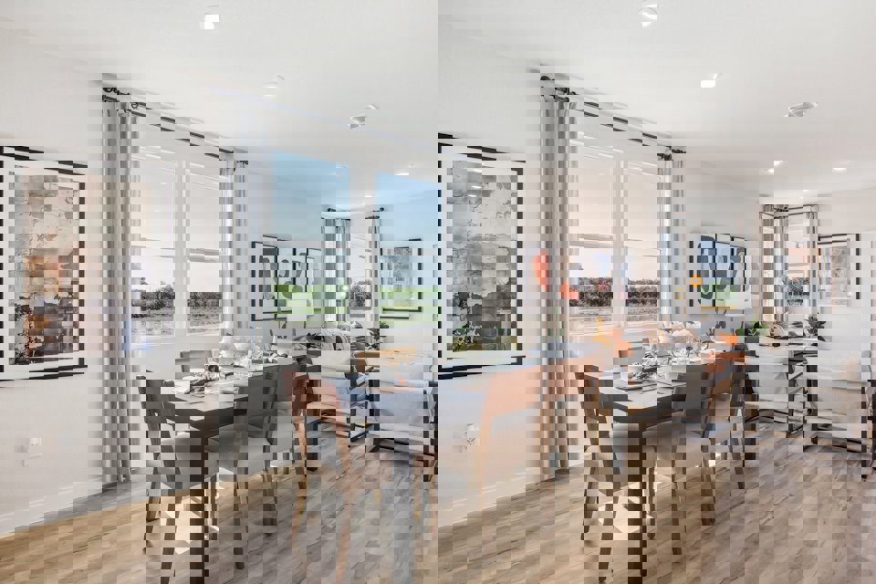 A dining room with a wood floor.