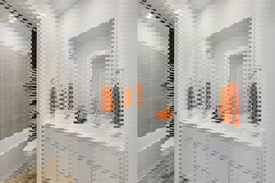 A bathroom with a sink toilet and bathtub.