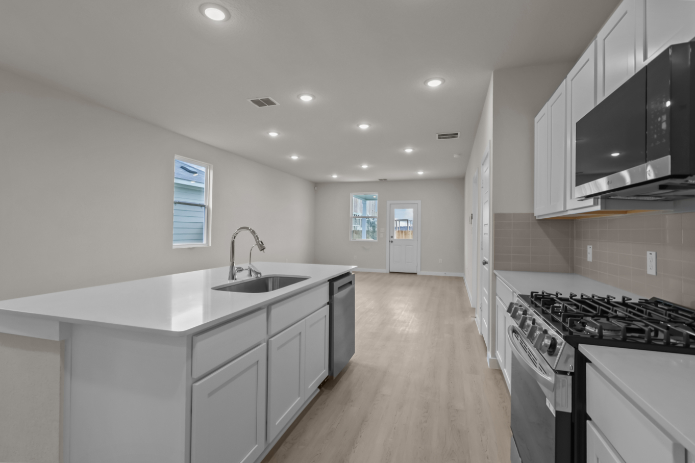 A kitchen with white cabinets.