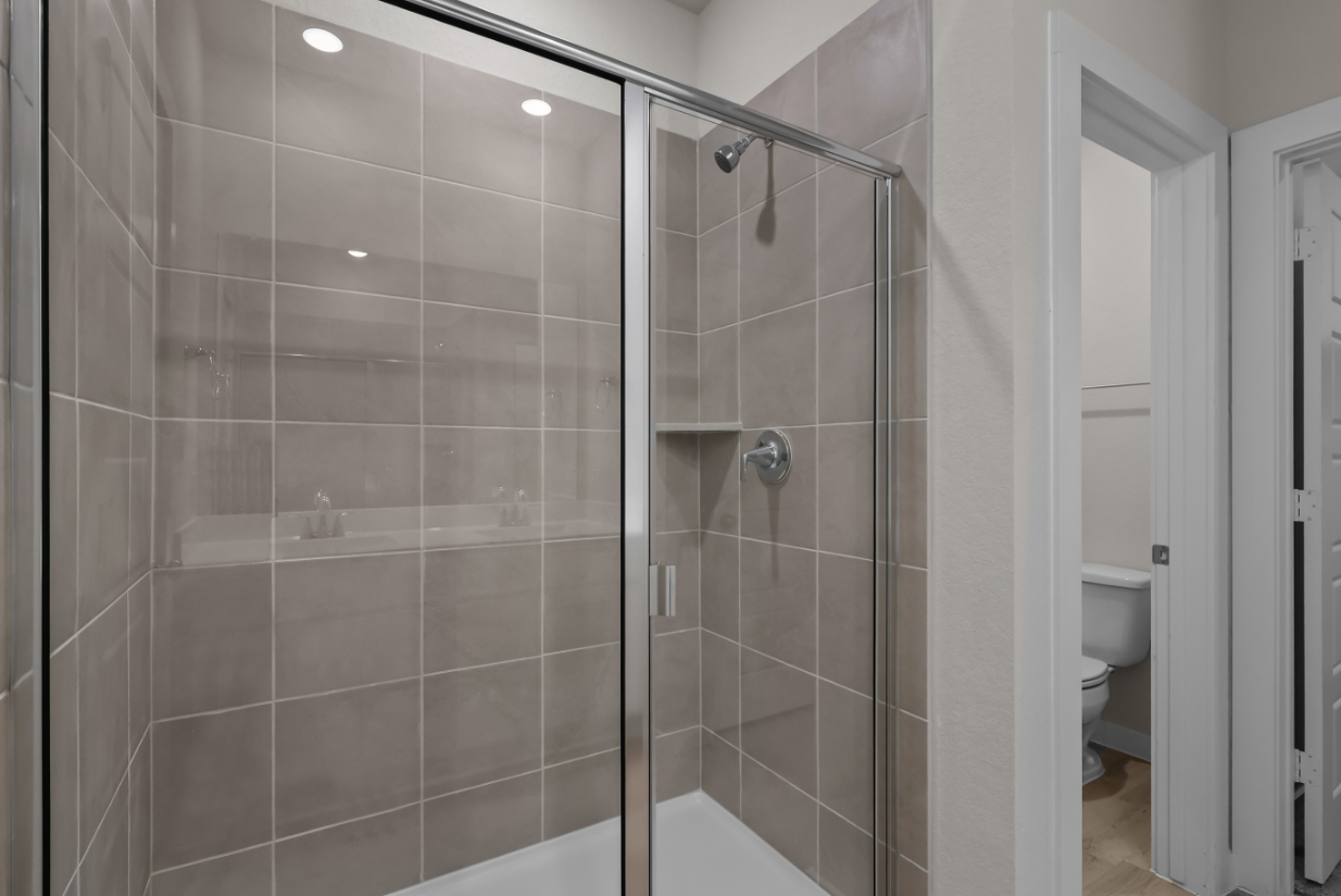 A shower with a glass door.
