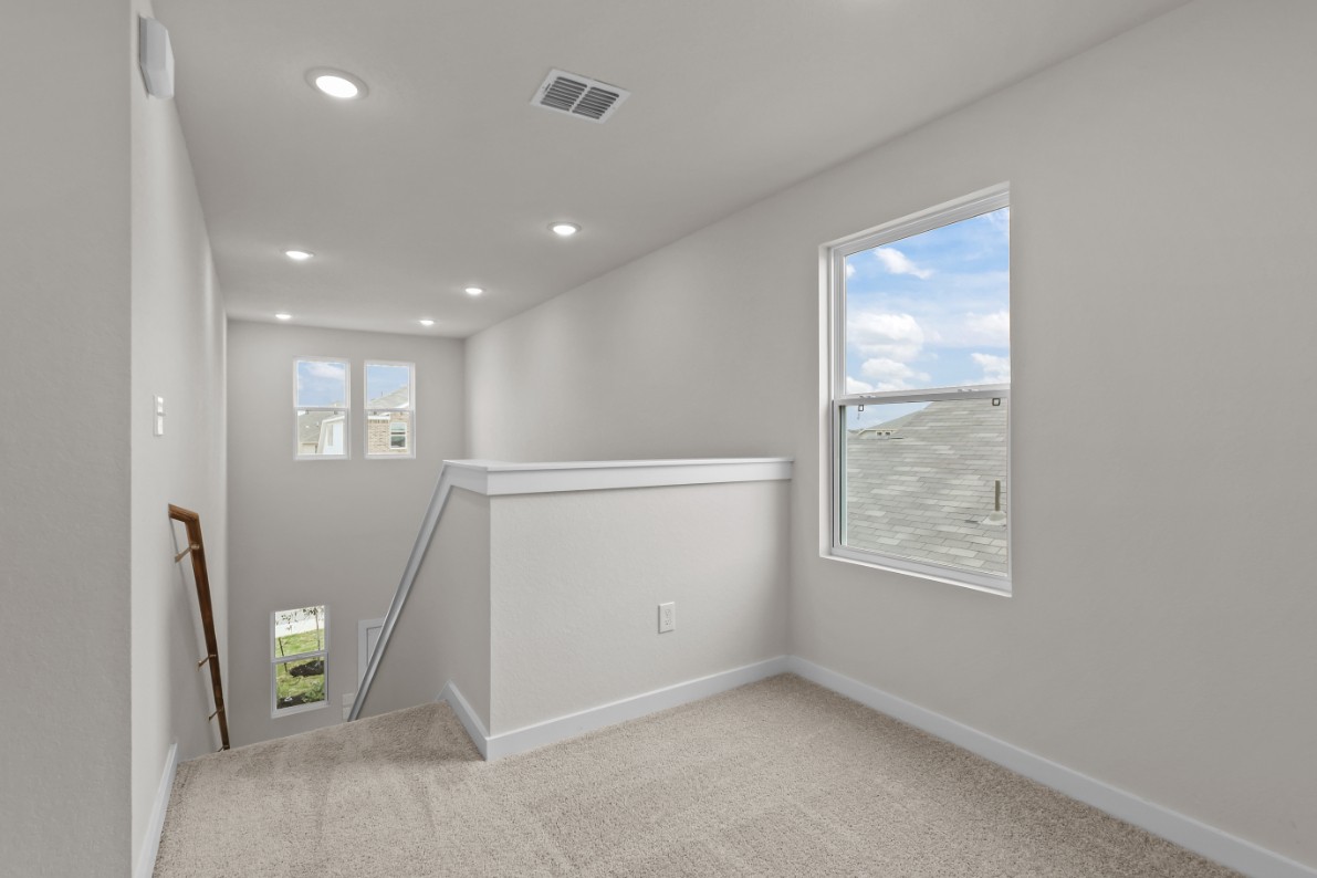 A room with a white wall and a white cabinet.