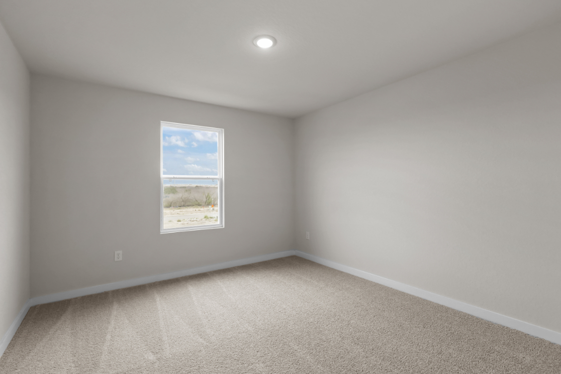 A room with a white wall and a poster on the wall.