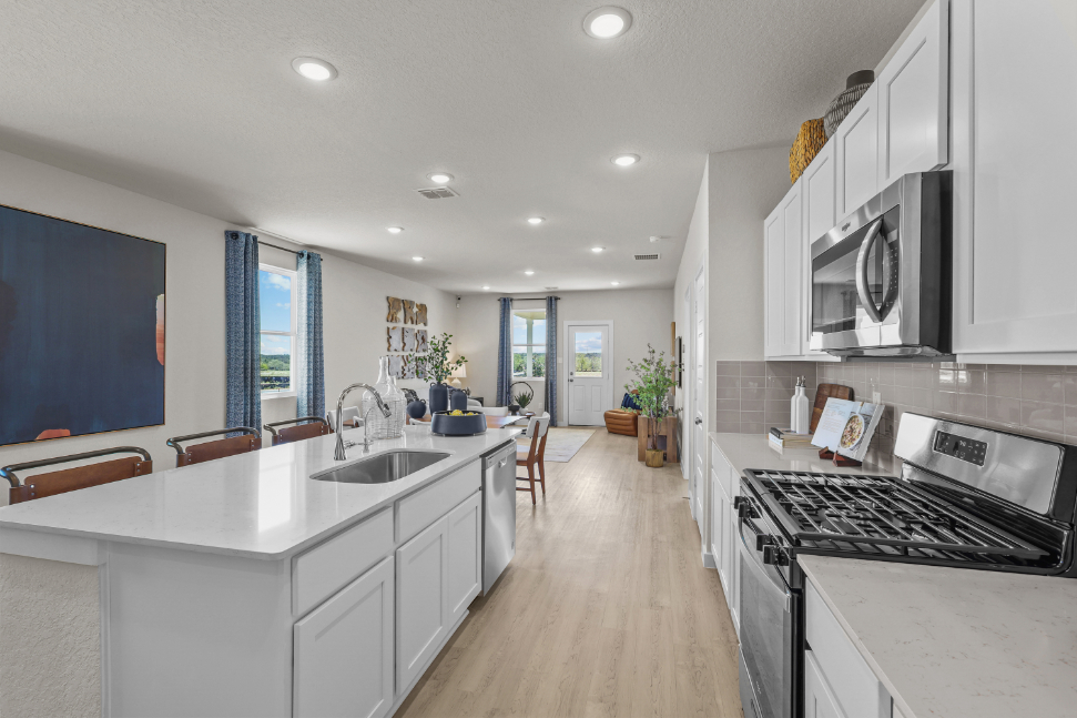 A kitchen with white cabinets.