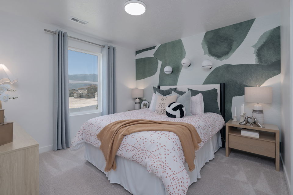 A bedroom with a bed and a window.