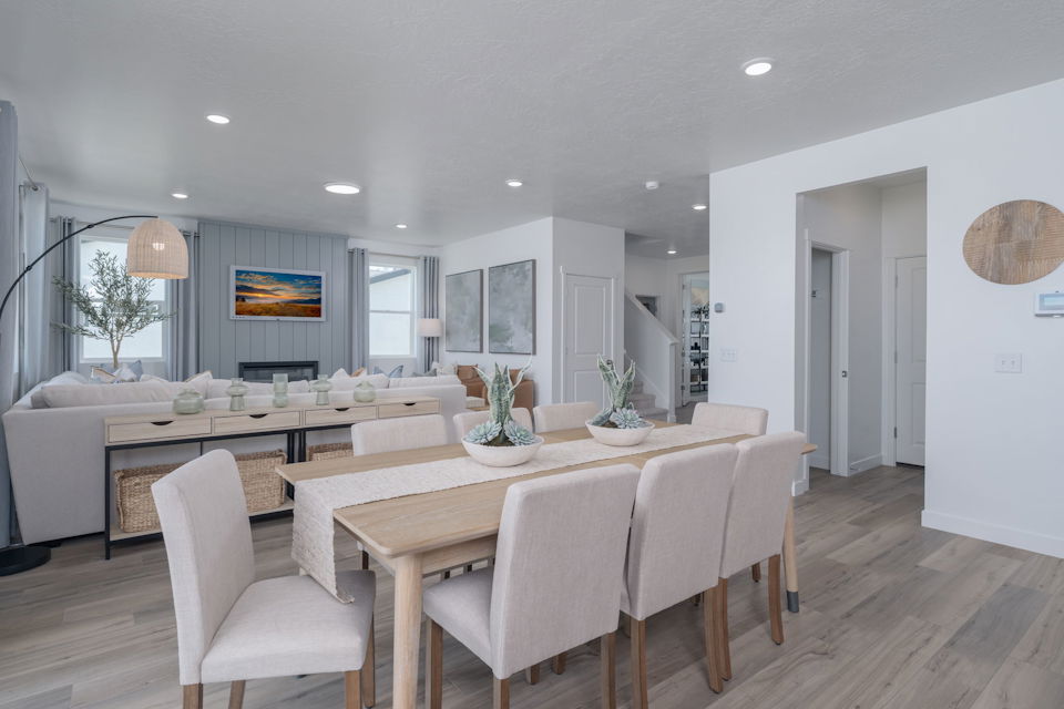 A dining room with a large table.