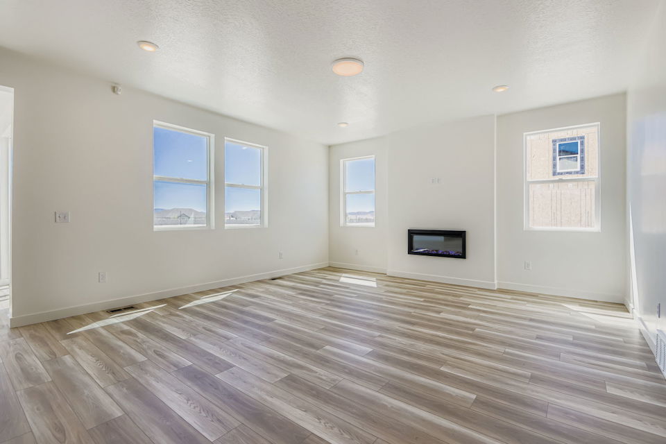 A room with a wood floor and white walls.