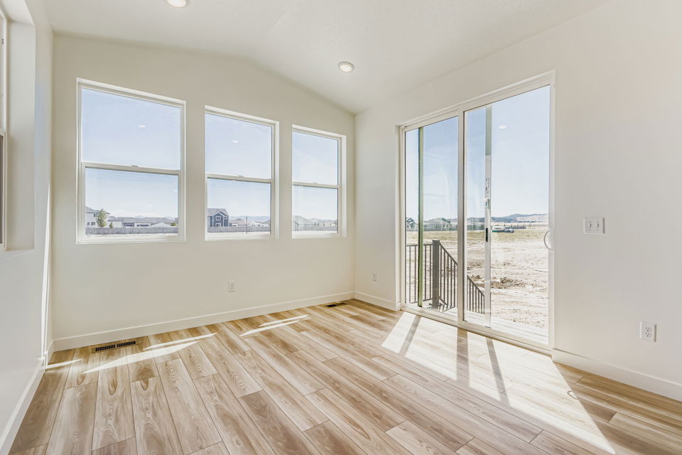 A room with windows and a wood floor.