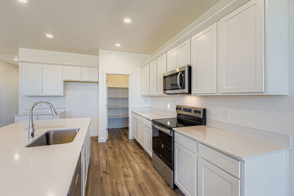 A kitchen with white cabinets.